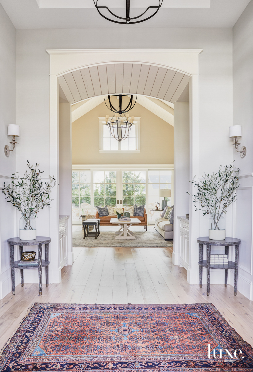 The entry provides a look into the great room that has a mix of modern and vintage furnishings.