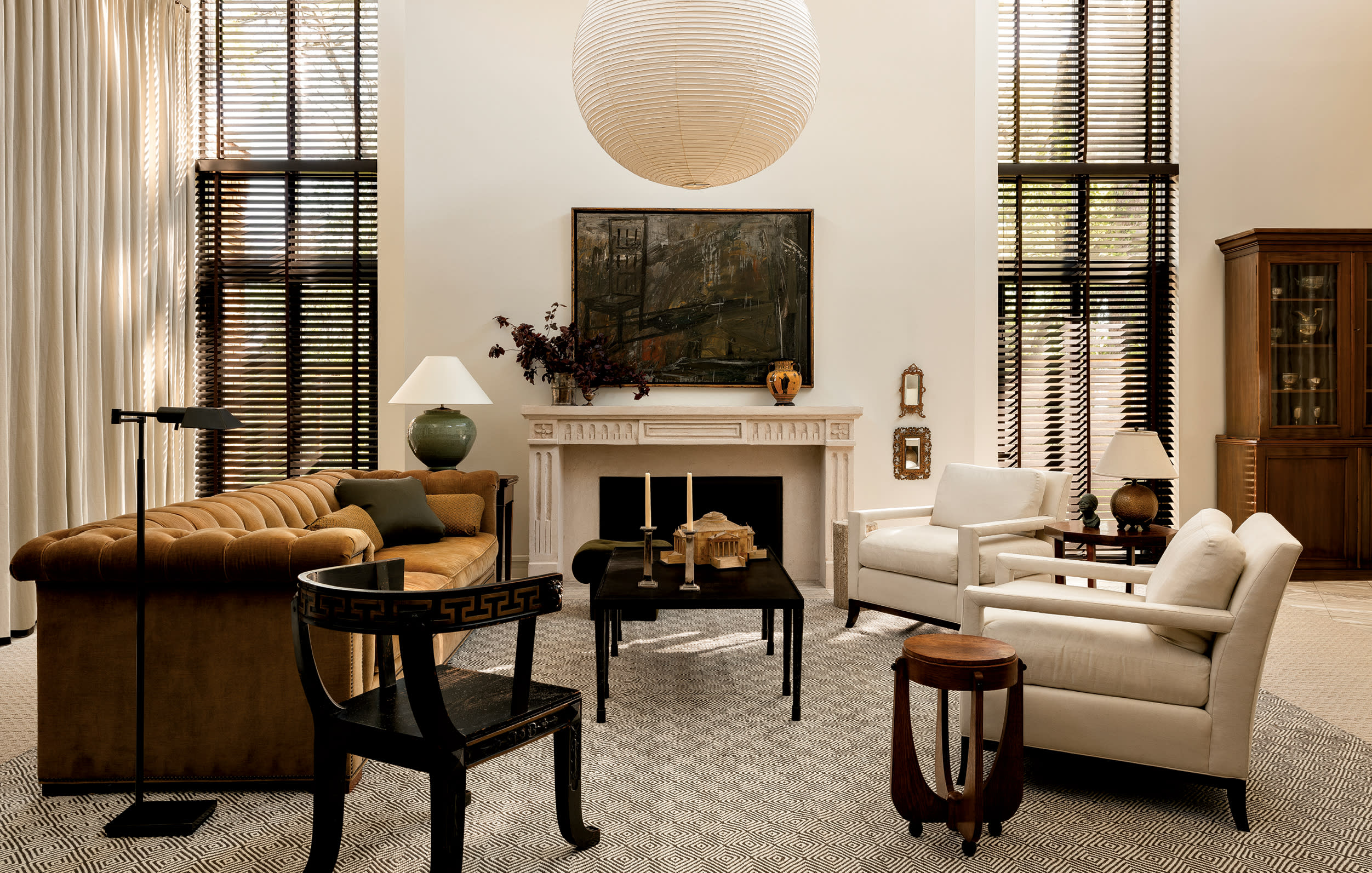 contemporary living room with warm neutrals including a large circular lantern pendant