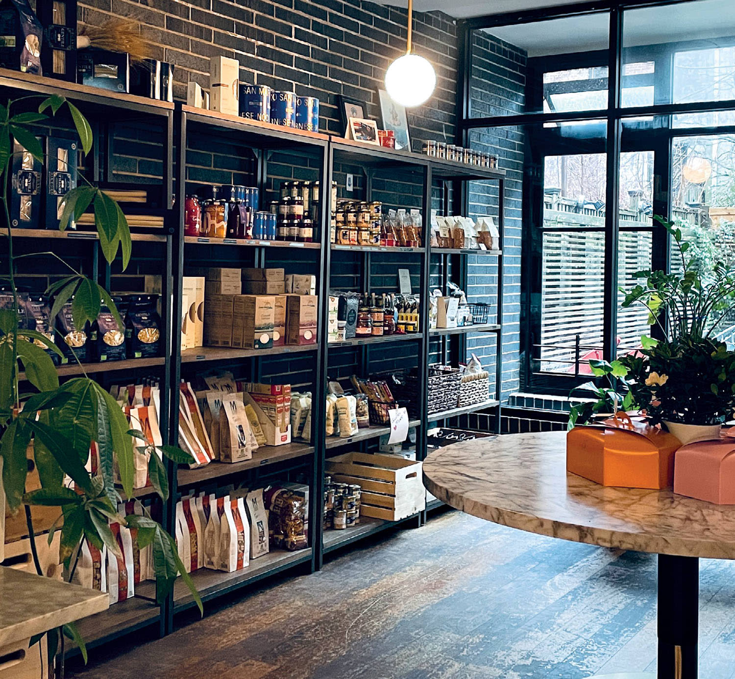 Store shelves packed with pasta and other food and kitchen items.