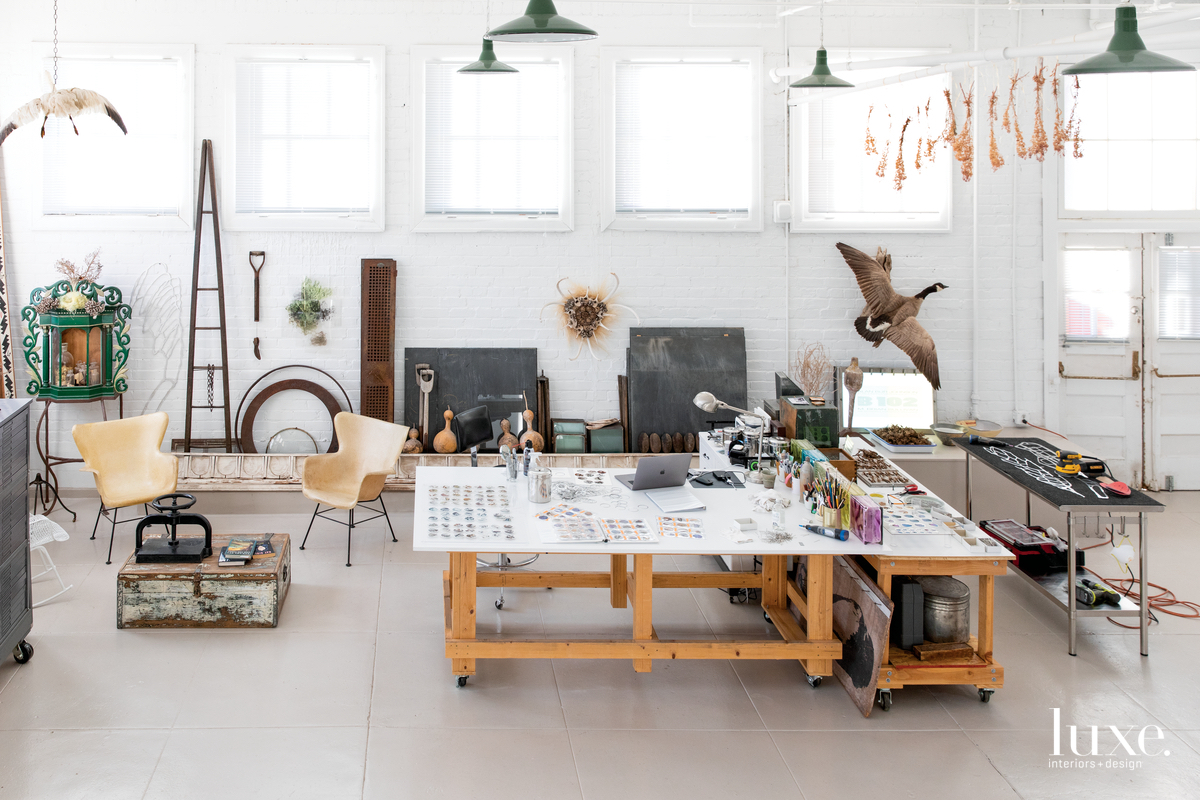 A large work table is the centerpiece of Johnson's light-filled studio, which he furnished with a pair of midcentury fiberglass chairs and a 19th-century nicho from New Mexico.