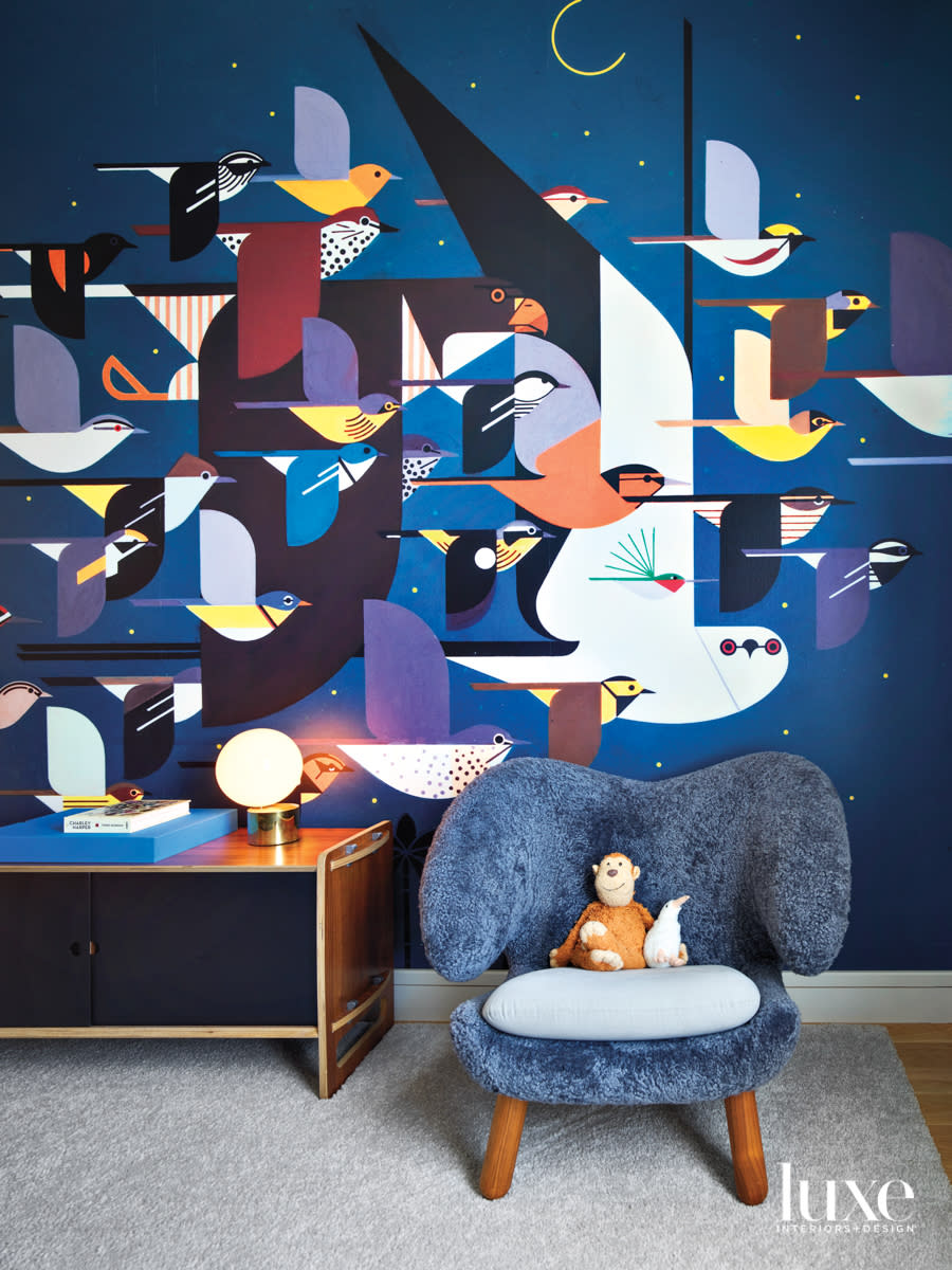 kids room with bird wallcovering and blue seating