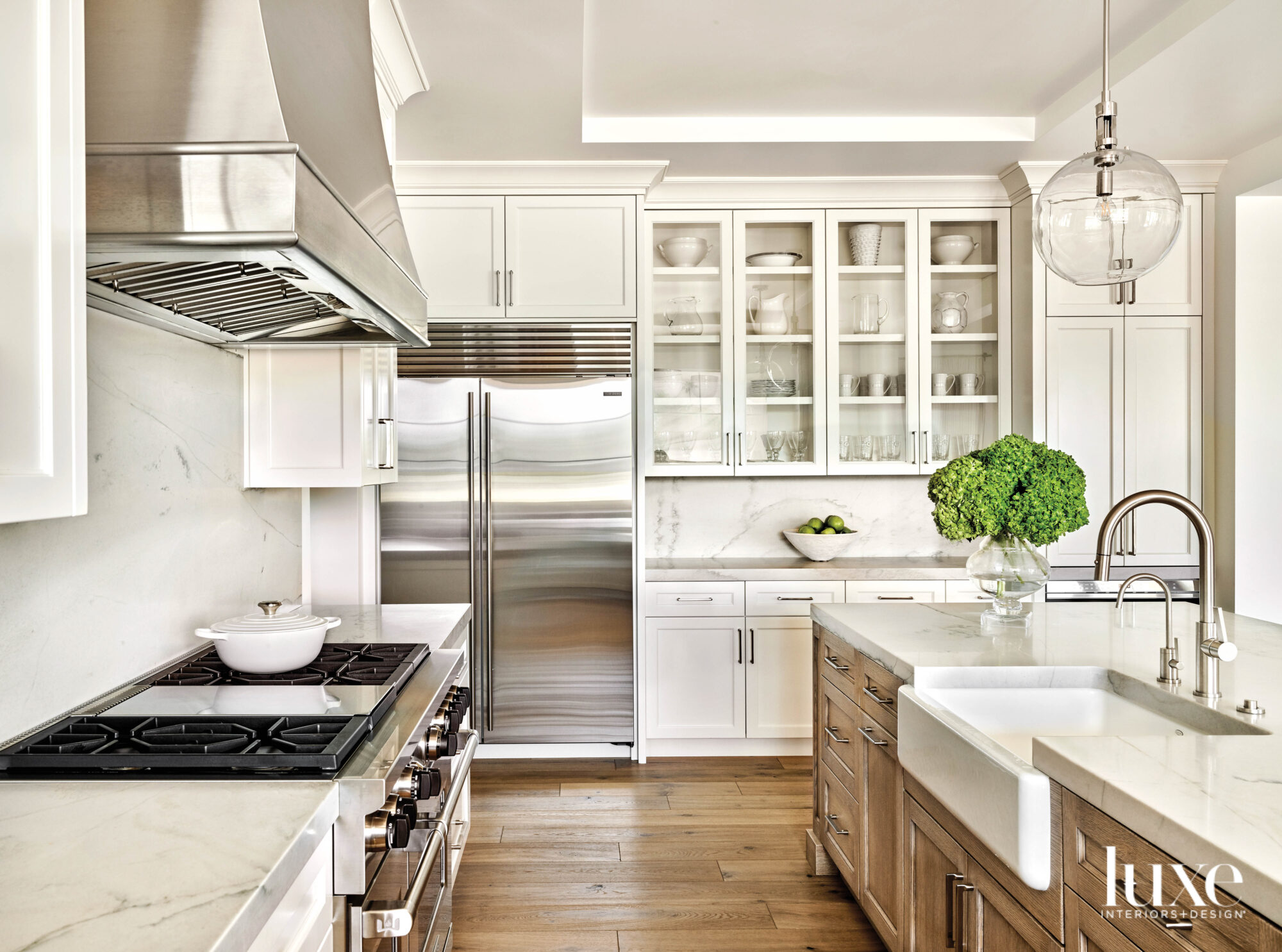 The kitchen has marble countertops and a farmhouse sink.