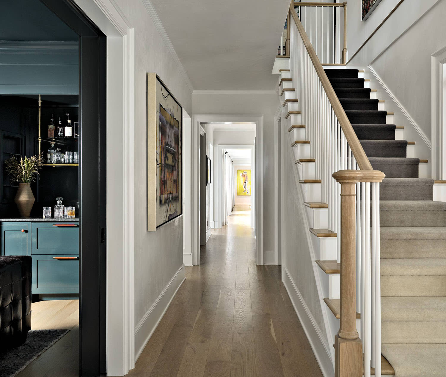 classic entryway with an ombre runner going up the stairs 