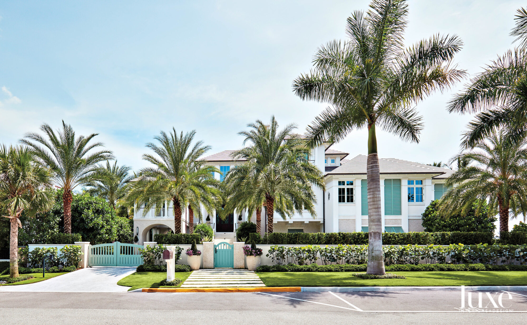 Exterior of home with aqua shutters and gates.