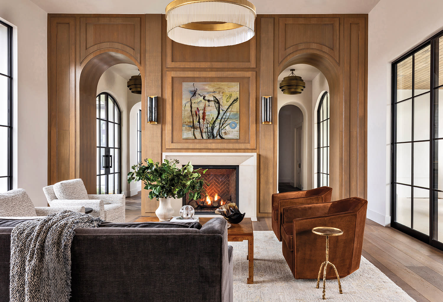 transitional living room with a wall of white oak paneling and custom molding