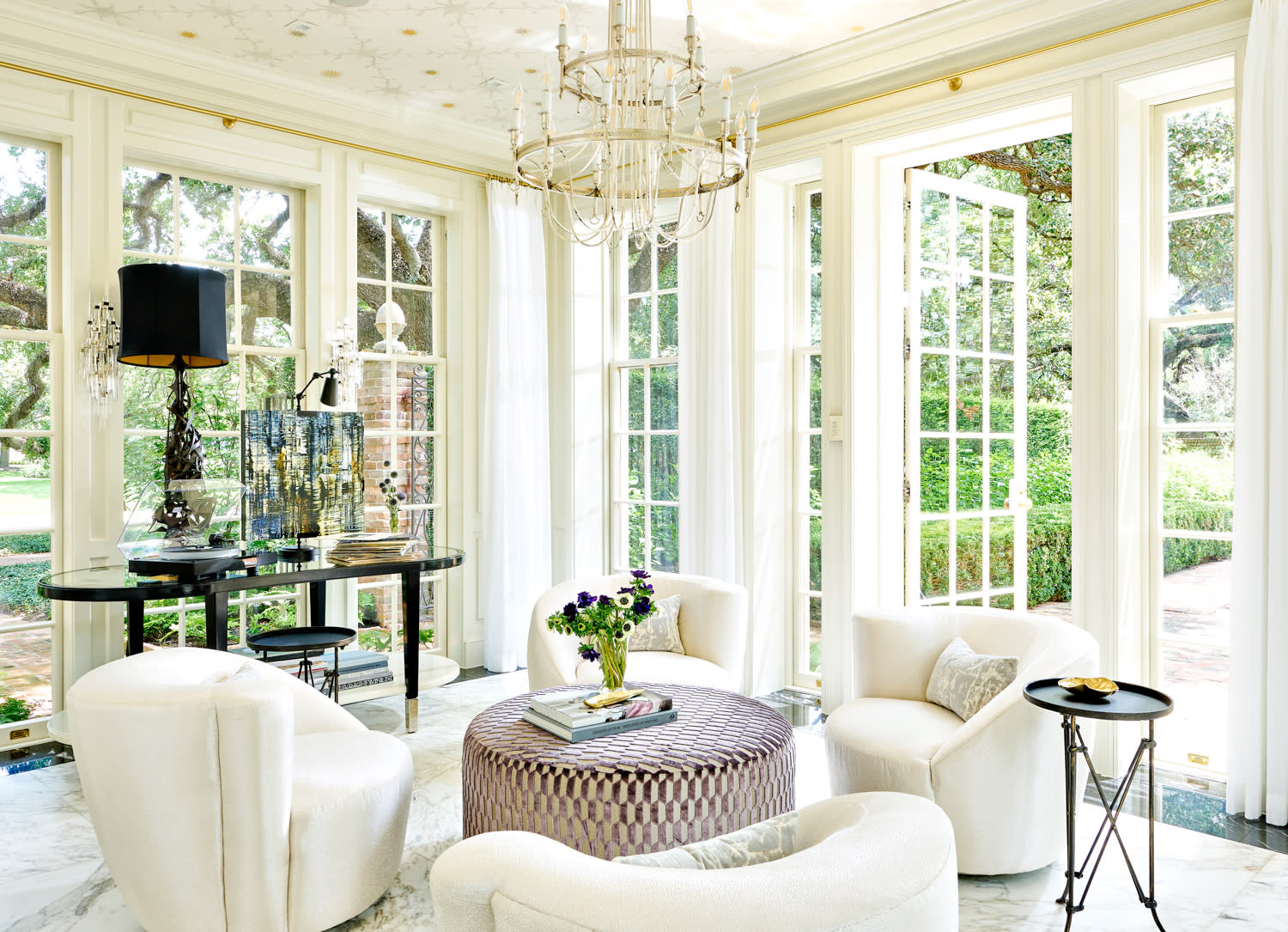 white Art Deco style living room with views of a garden beyond