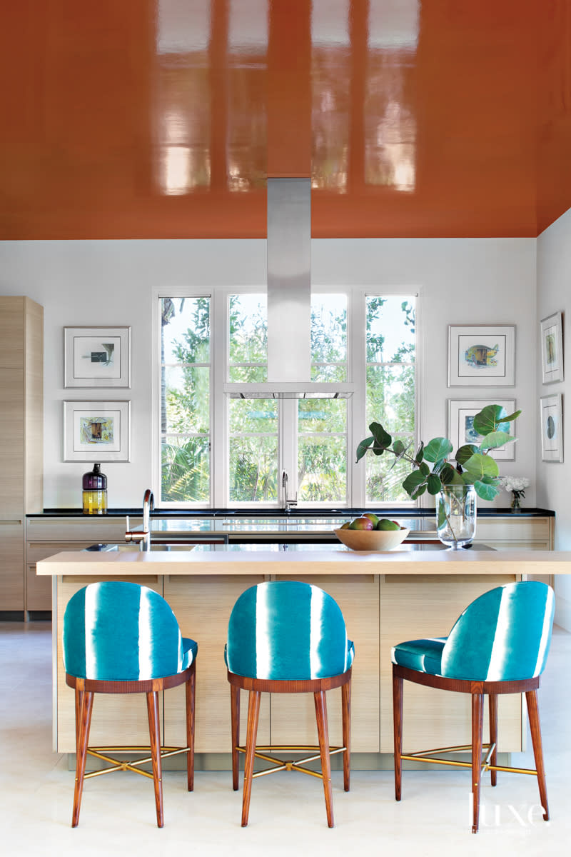 kitchen island with teal hickory chair barstools in home by Peter Moor