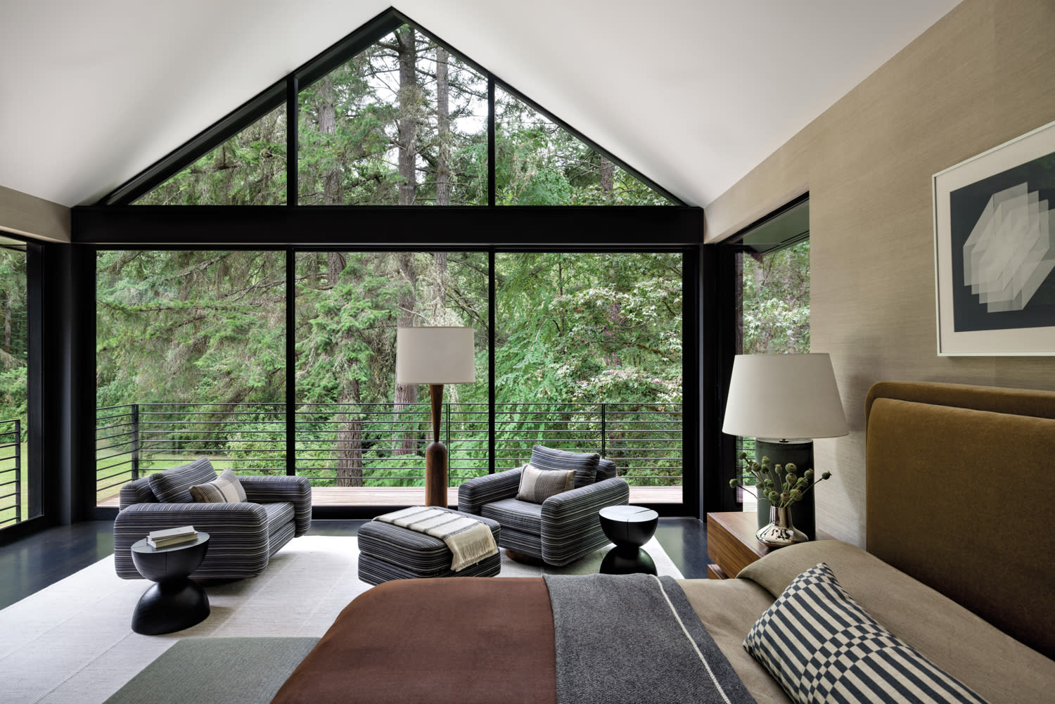 contemporary Pacific Northwest-style bedroom in neutral hues with views of the forest