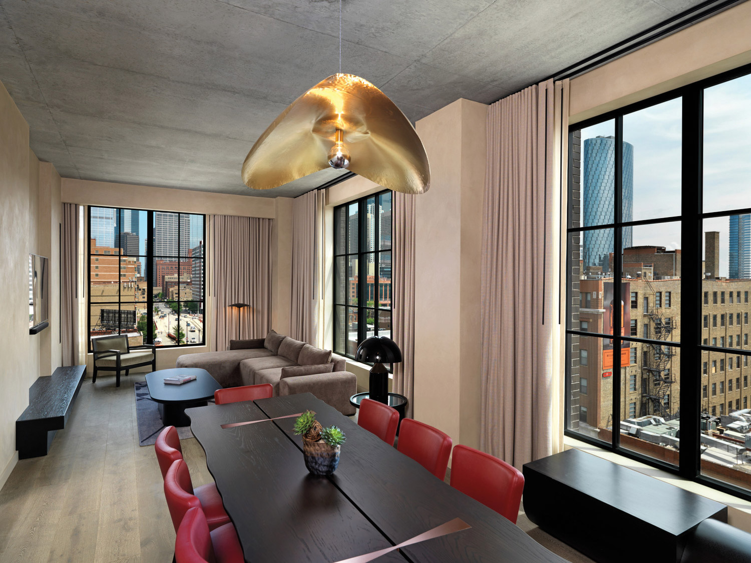 Dining table with red chairs in hotel suite