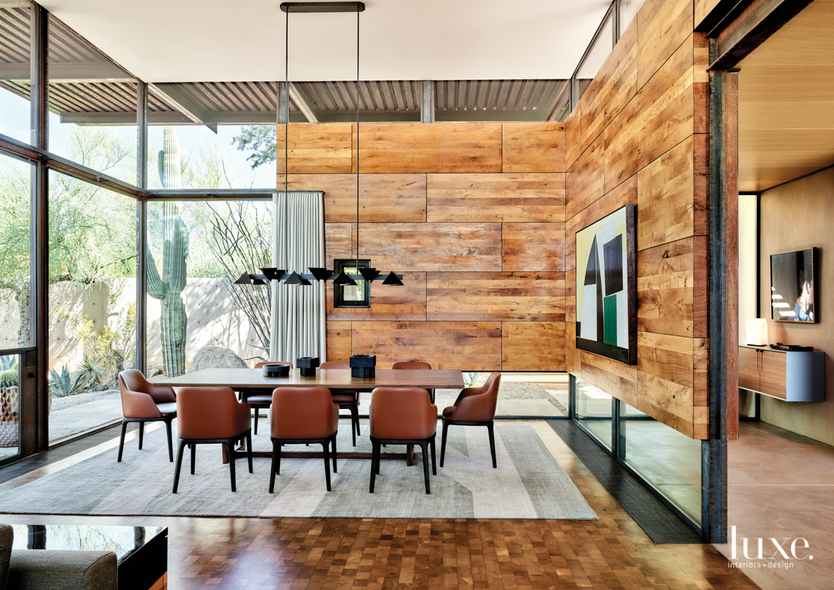 Dining room with simple designs and a Jonathan Browning light as the centerpiece of the room.