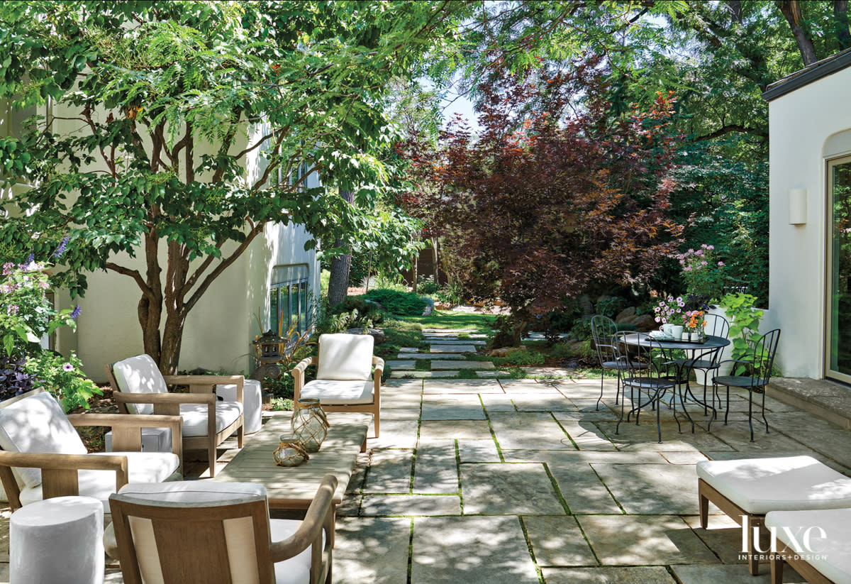 Courtyard filled with lots of seating, trees and tables