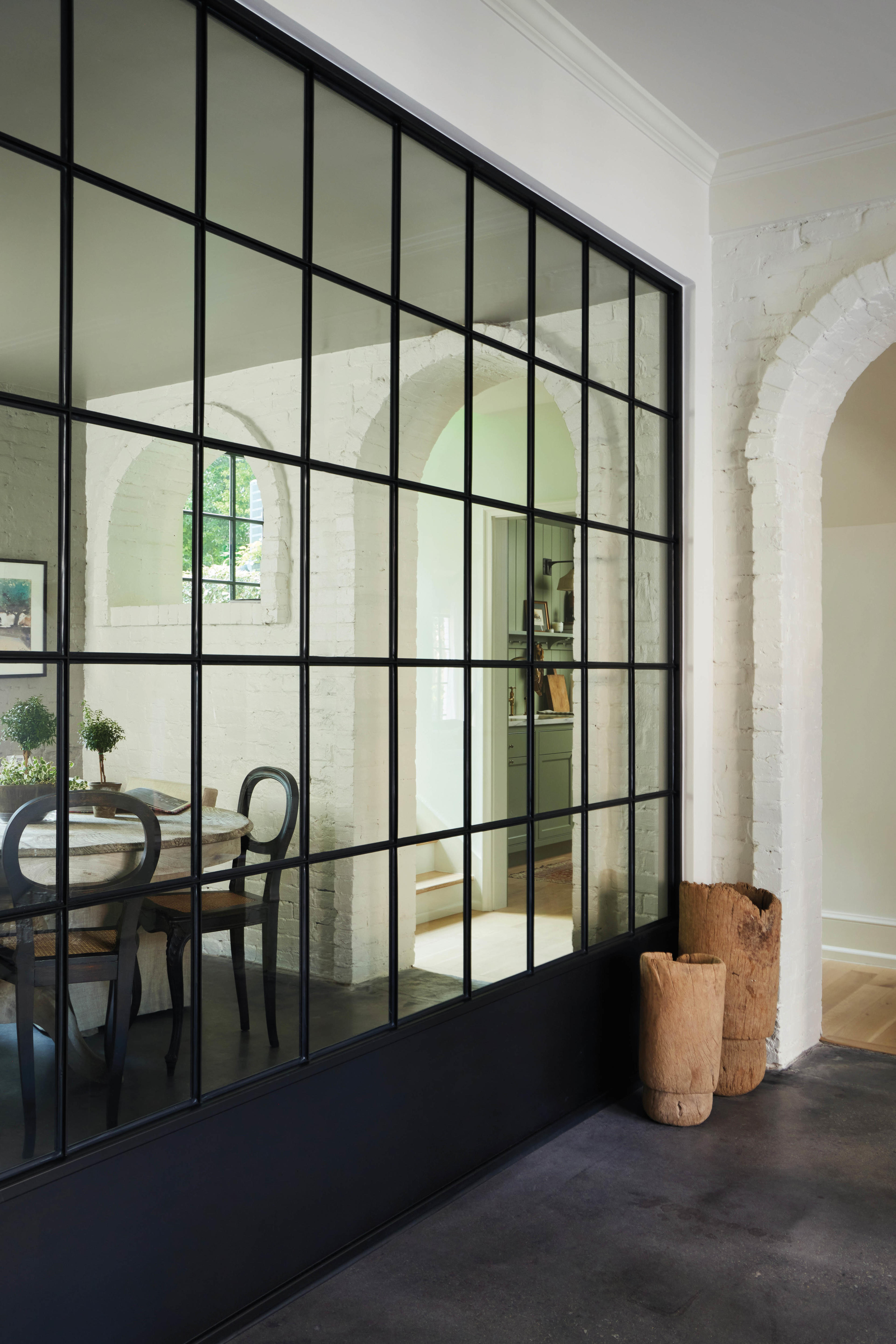 black detailed partition separating a living and dining room