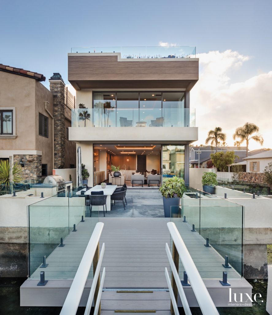 dock with glass railings and house exterior