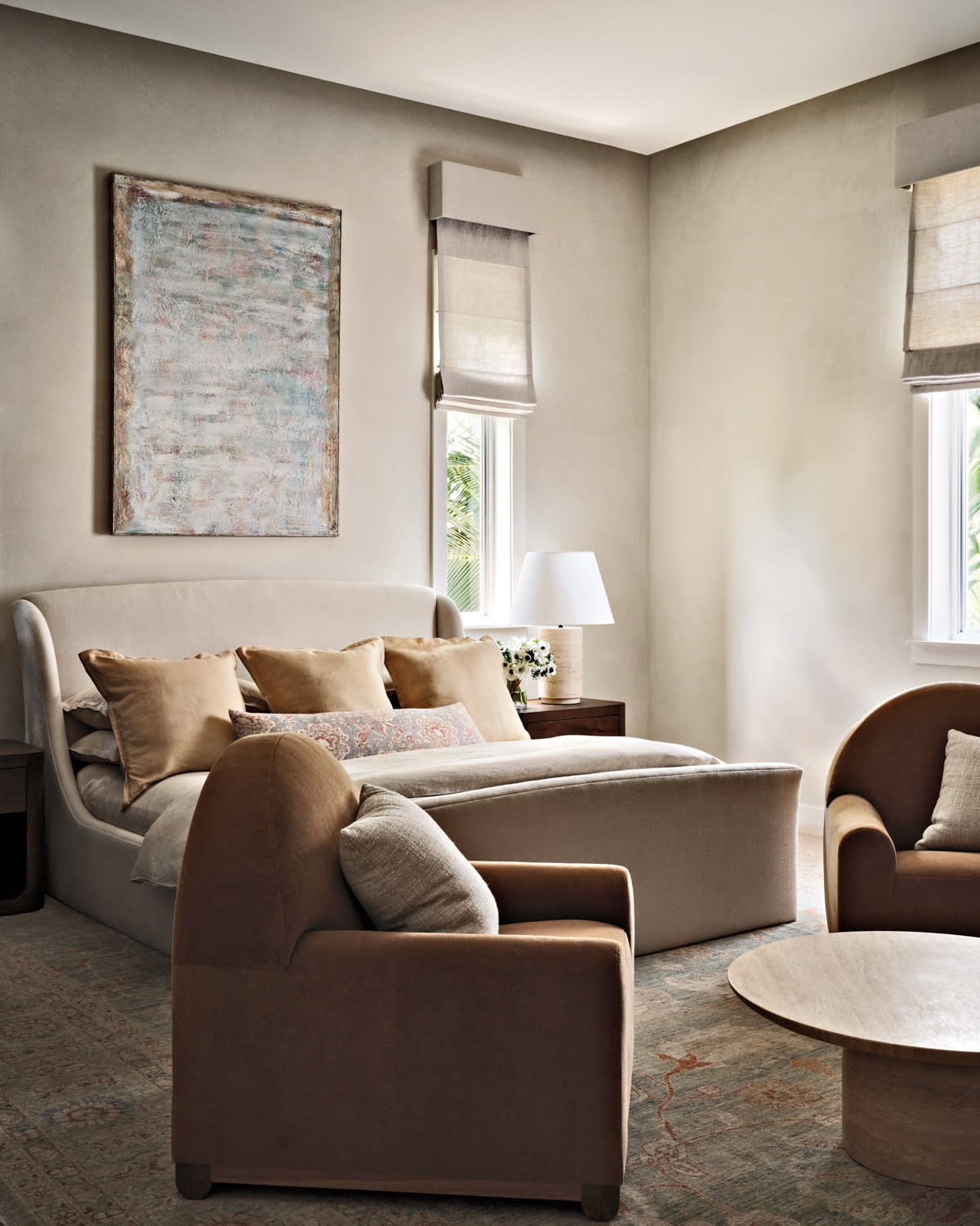 neutral bedroom with a vintage oil painting above the bed