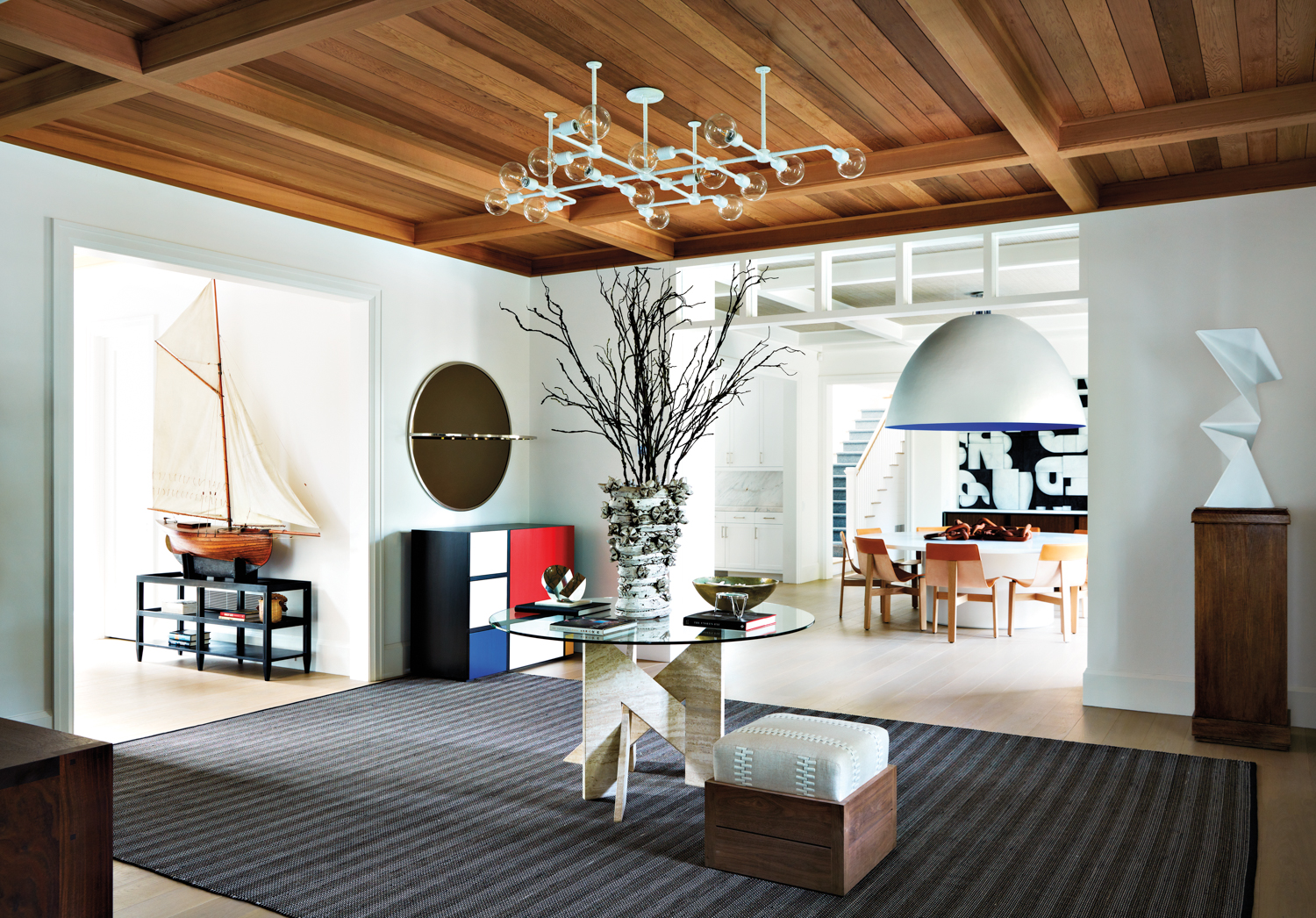 entryway features glass table and treelike centerpiece