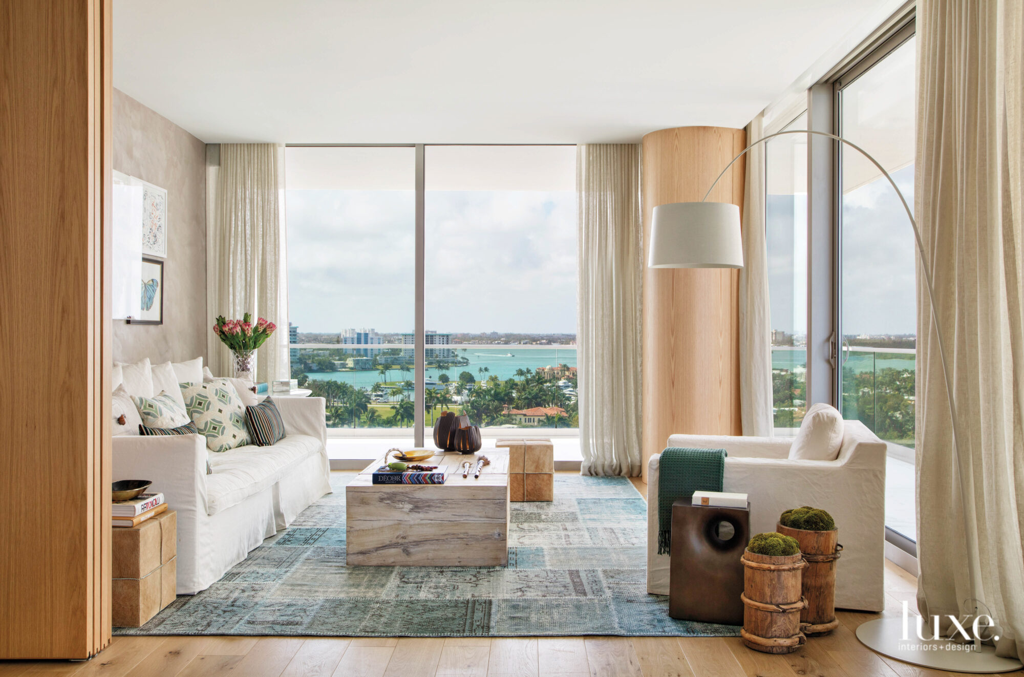 modern family room overlooking Miami shines with organic textures and veined coffee table