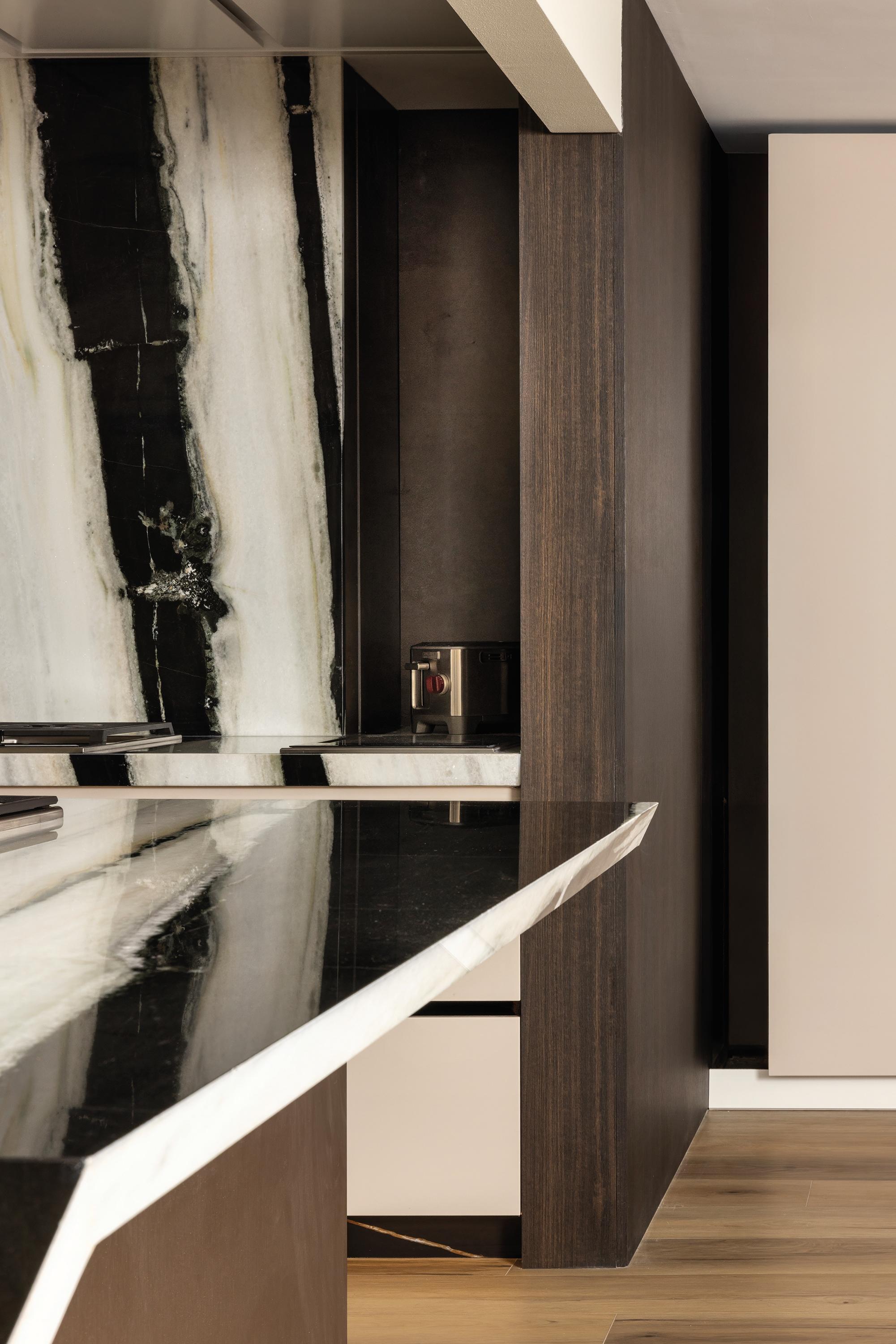 Close-up of the custom stone countertop edge in the Pazzam Project kitchen, demonstrating meticulous fabrication and architectural geometry.