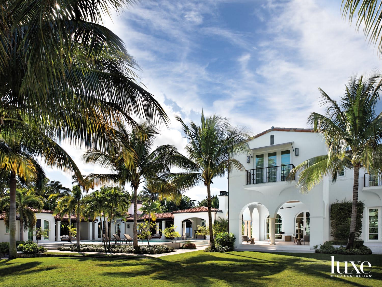 exterior space of mediterranean-style home with grounds and pool