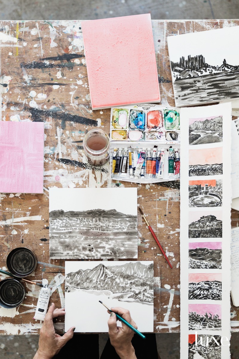 Bumiller reviews a vertical strip of watercolor studies for her Monumental series, which includes the partially finished work Tonto National Monument