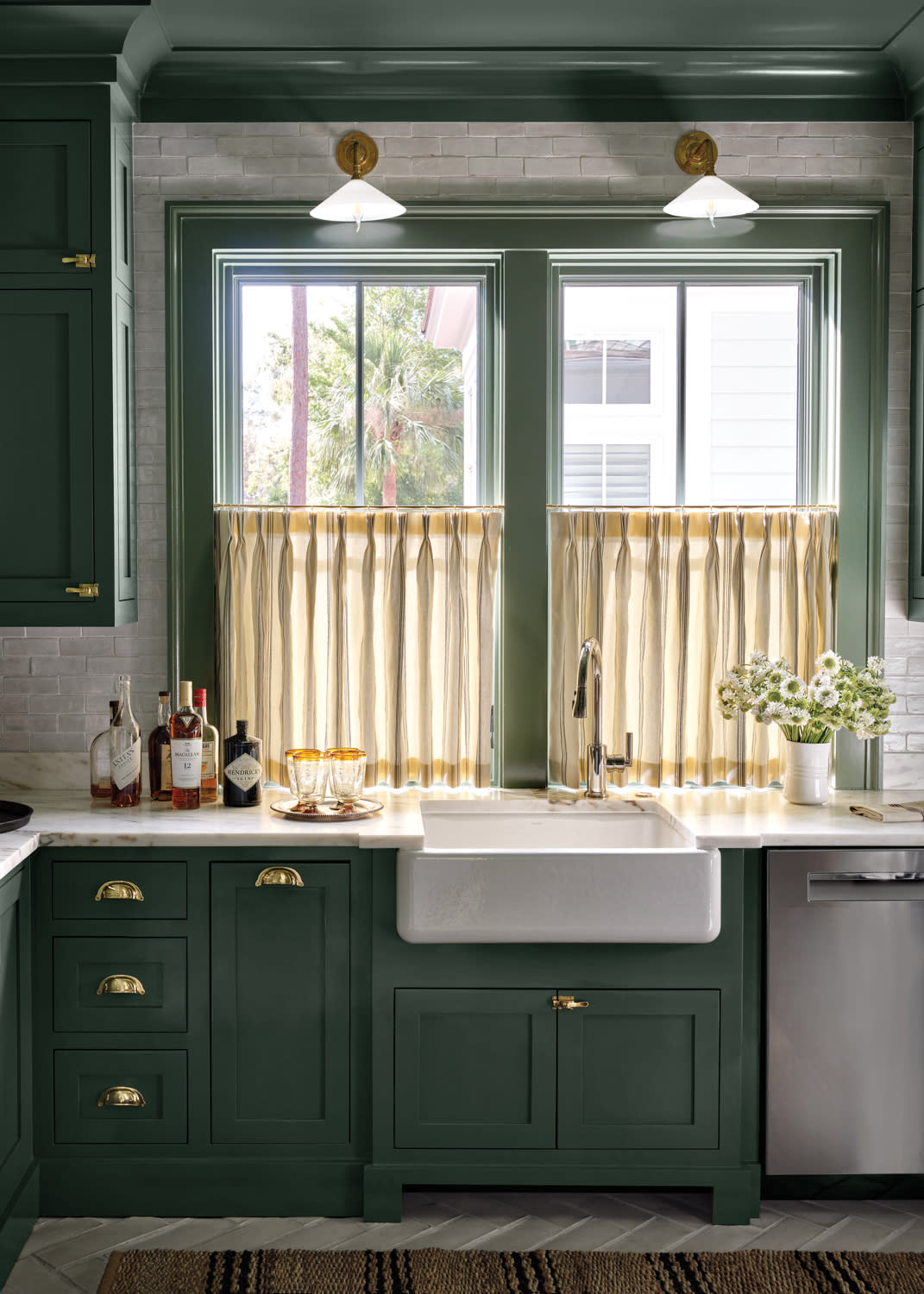 dark green butler's pantry with a farmhouse sink