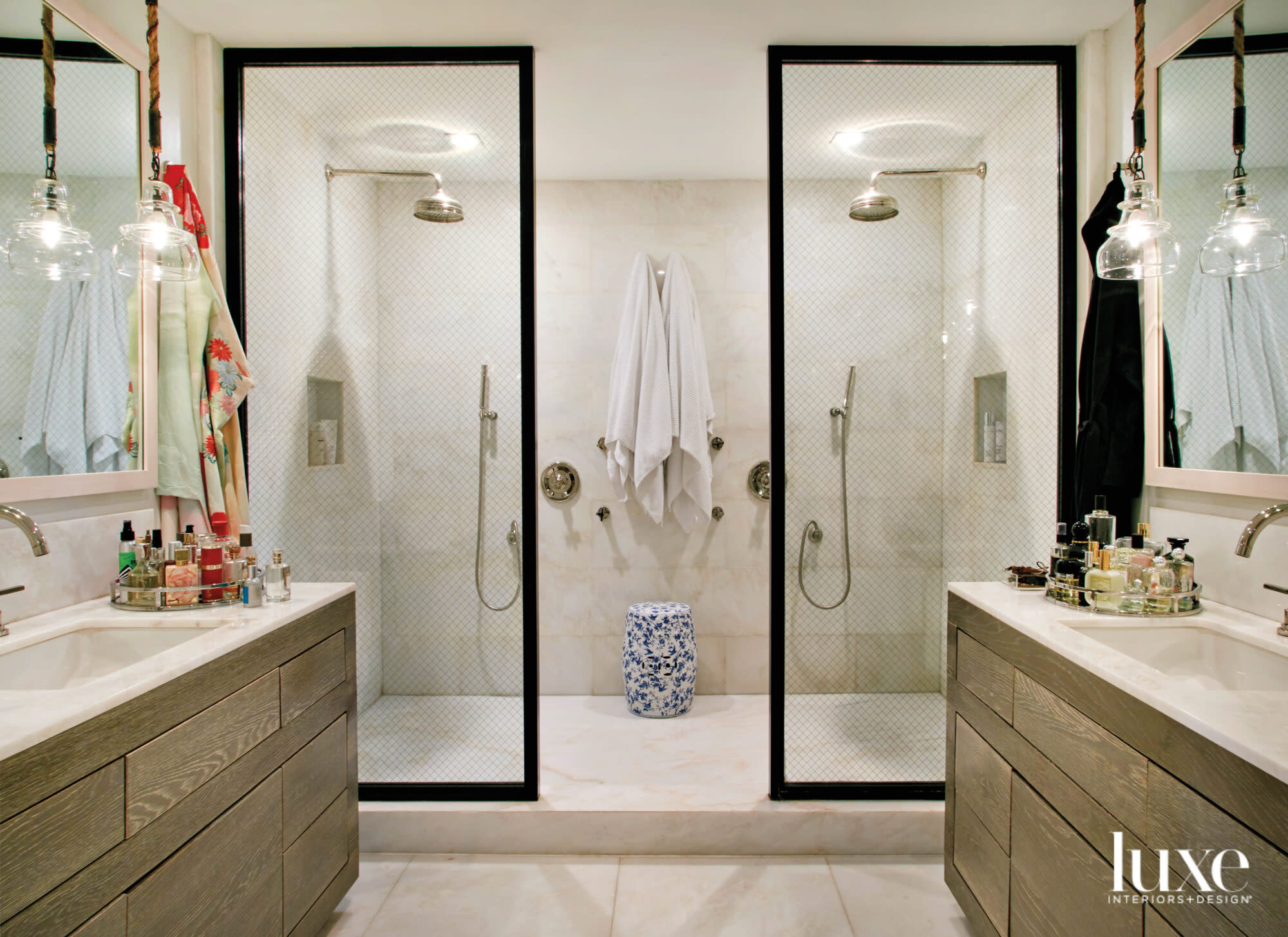 bathroom with black-framed glass shower walls and blue-and-white stool