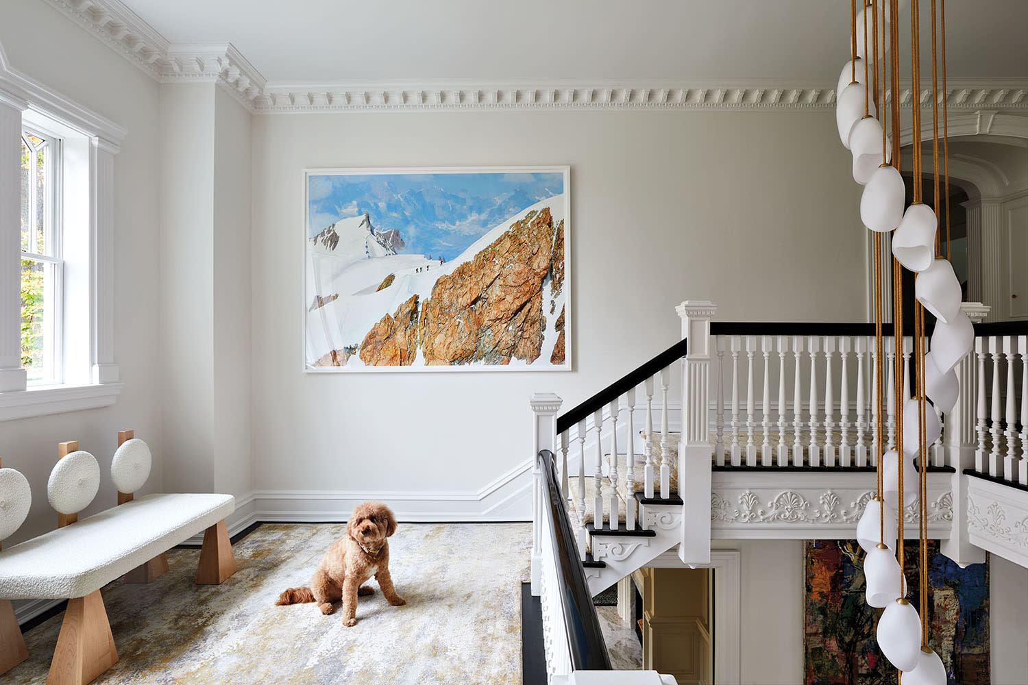 gallery-like staircase landing with a dog in front of a sculptural bench
