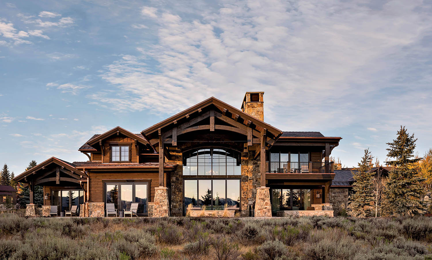 Utah cabin exterior made of cedar siding and Wyoming moss rock