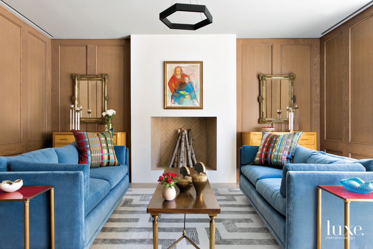 eclectic living room blue sofas brown walls