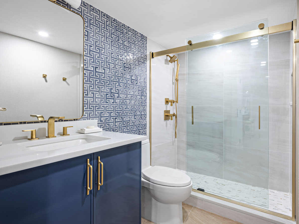 Bathroom with blue vanity, white countertop.