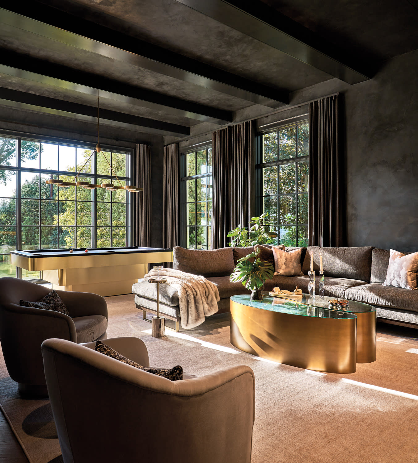 moody game room/lounge with black walls and a brass-base pool table