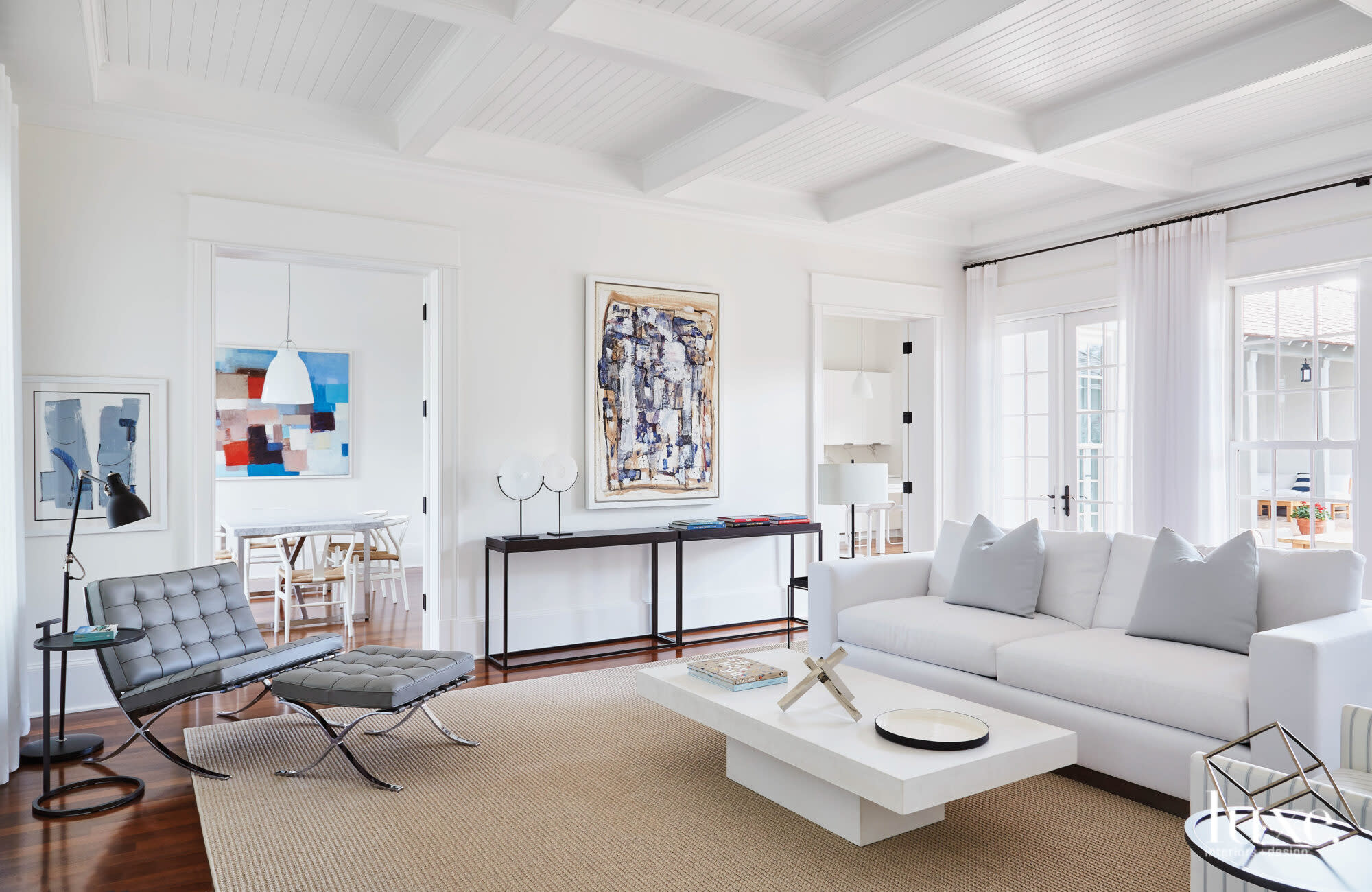 Living room with abstract art against white walls.