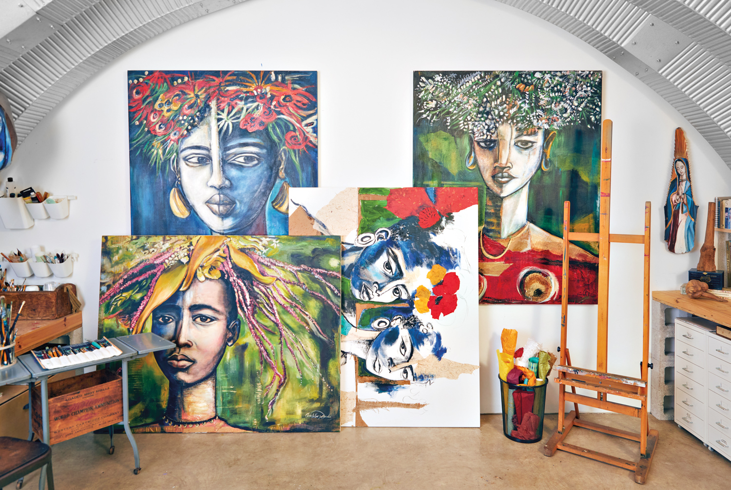 collection of collaged portraits in artist studio