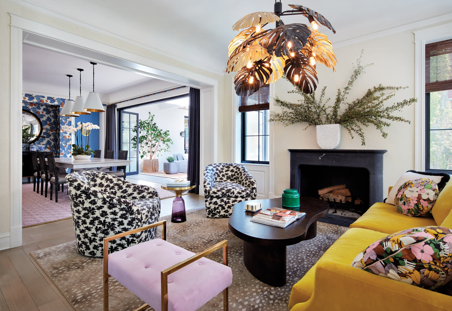 bright and eclectic living room with yellow, pink and black-and-white furnishings