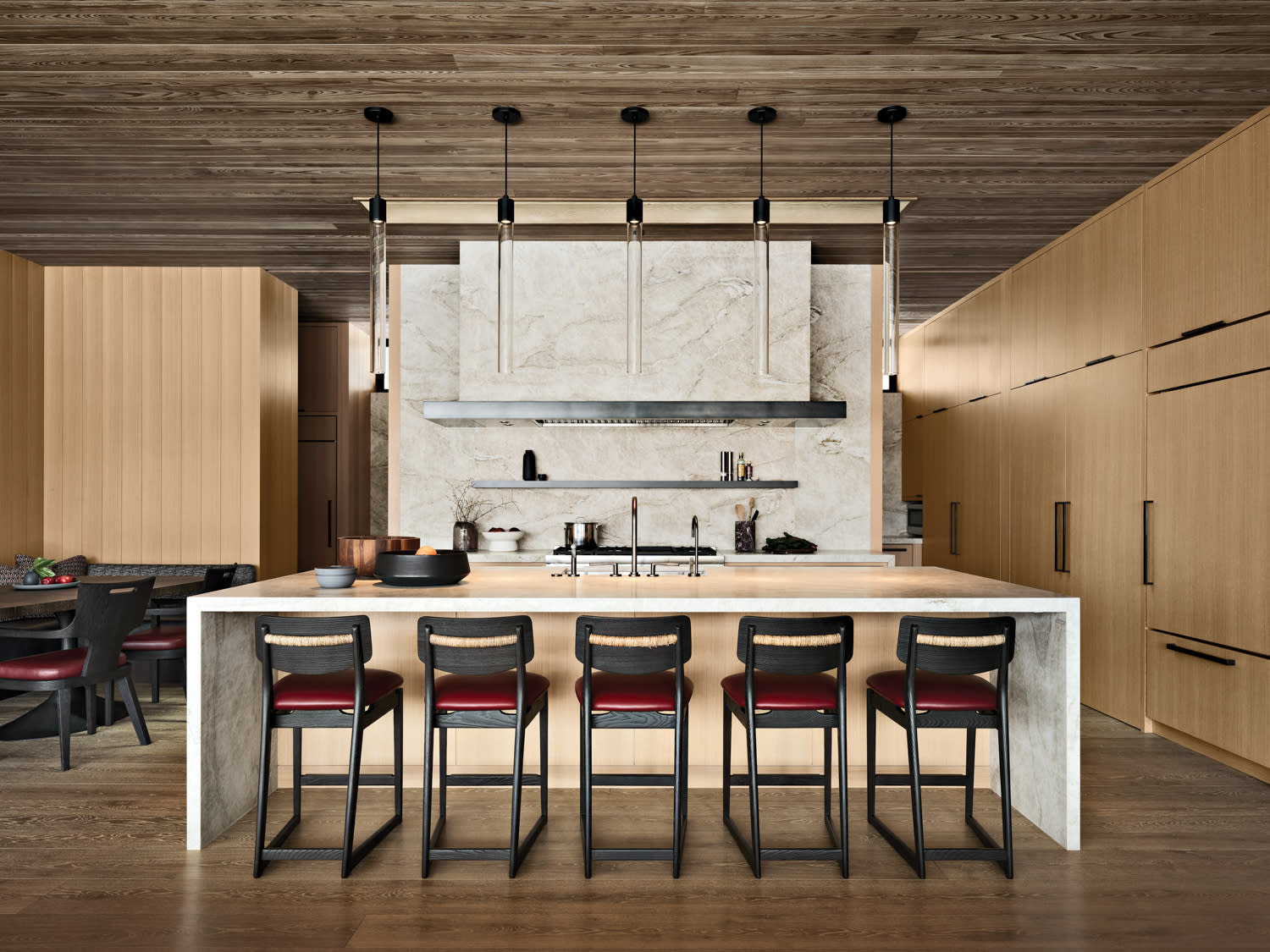 mountain home's kitchen with various woods and a long island