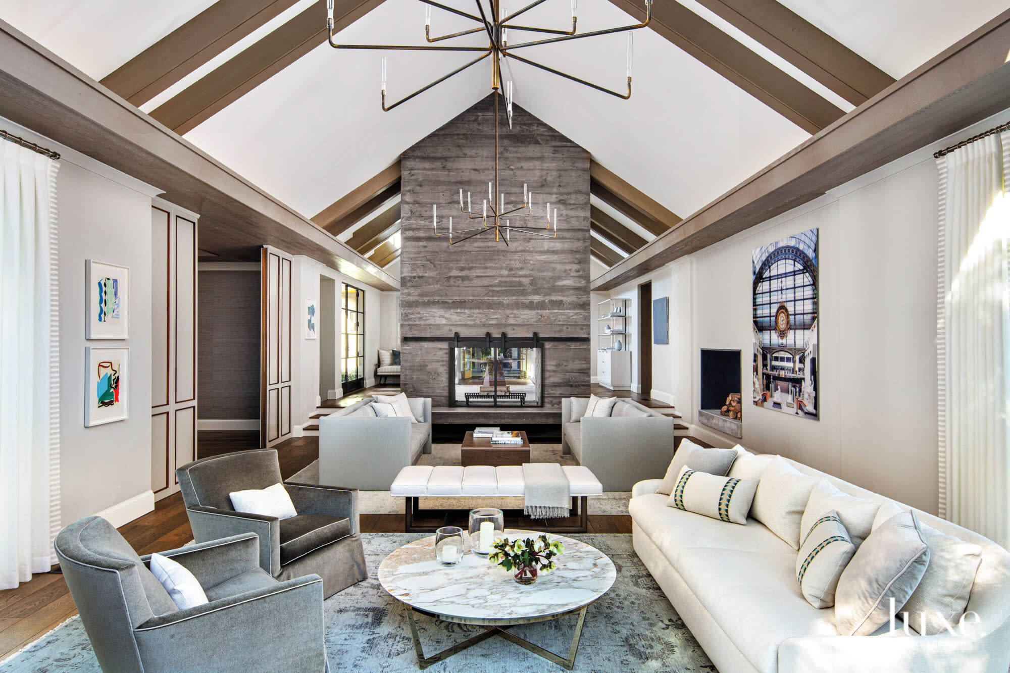 The living room features a seating area in front of the fireplace.