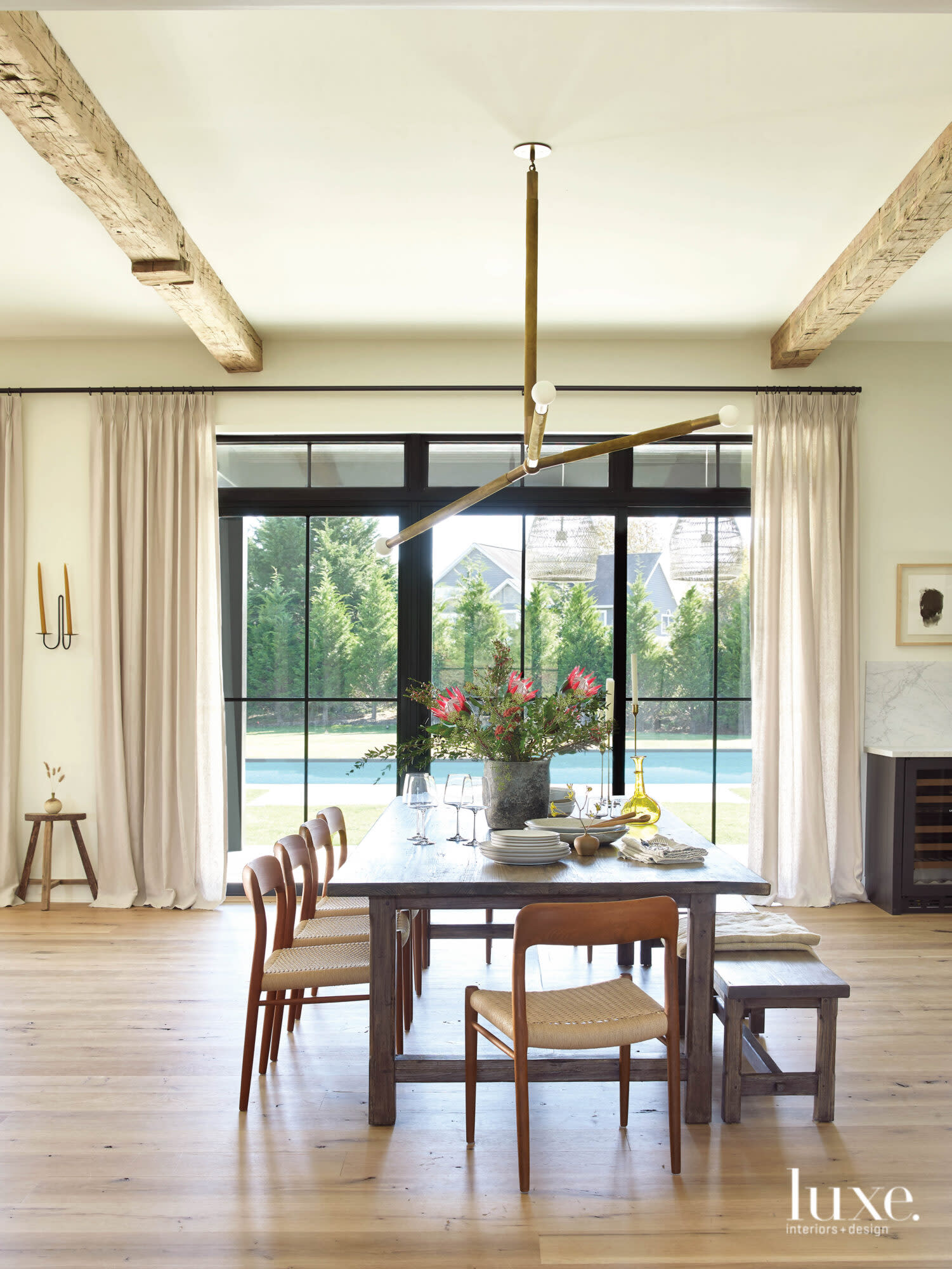 The dining room sits in front of a view of the pool