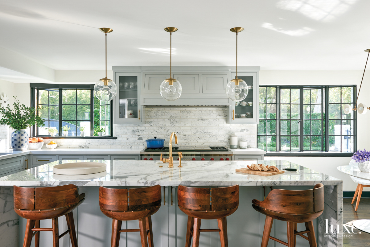 kitchen with circular light pendnats, grey and white marble island countertop