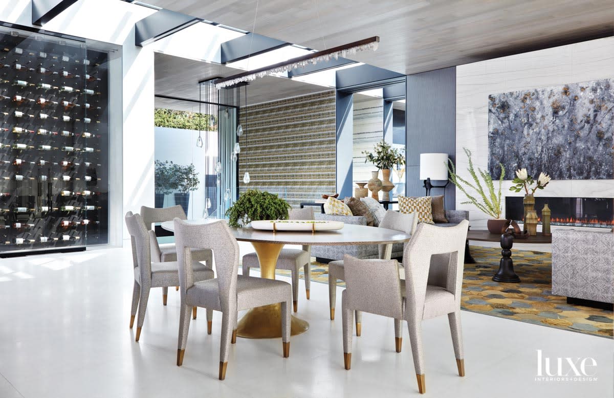 Dining area with a table with a gold base and chairs with gold-tipped legs