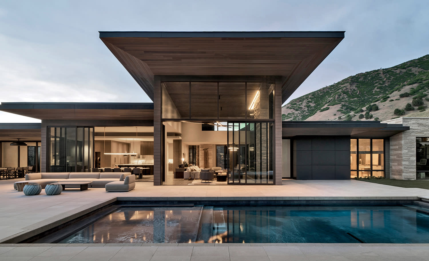 angular, contemporary home exterior overlooking a pool deck in Utah