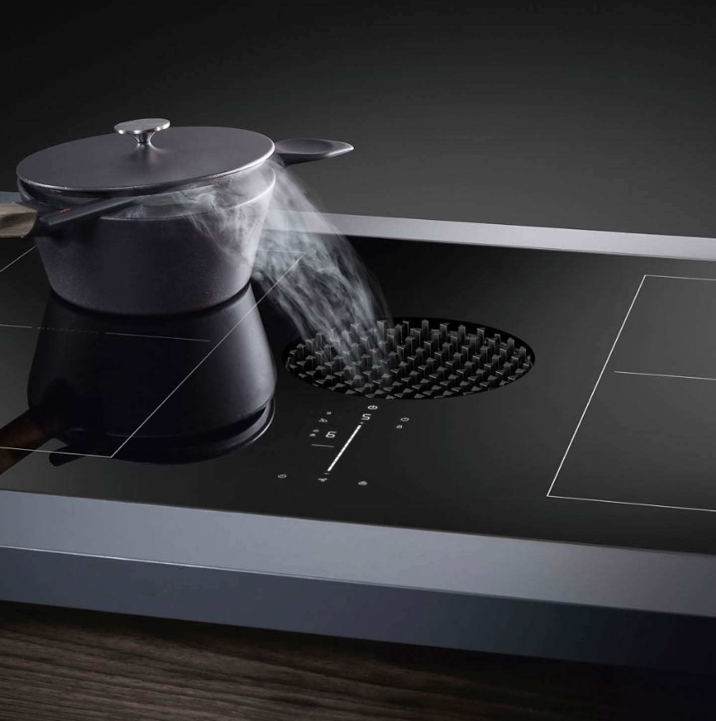 Modern cooktop with a black pot on an induction burner.