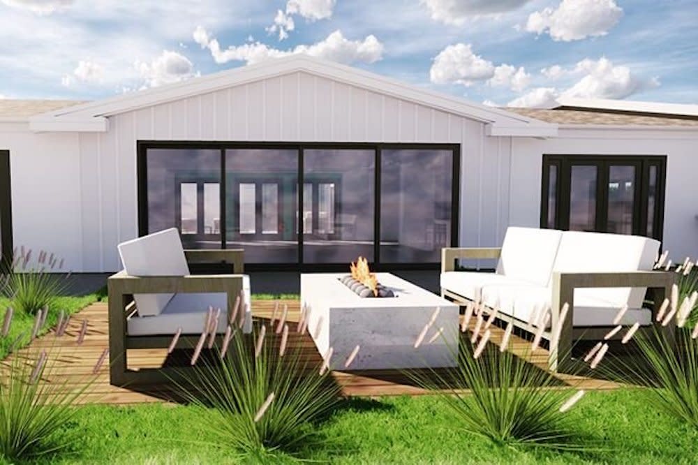 A contemporary white home with large black window and white patio furniture by Kabbany Architecture in Southern California.