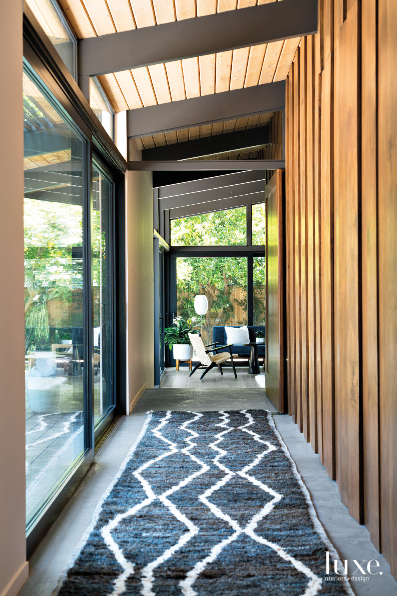 View of hallway with gray runner and view into the master bedroom