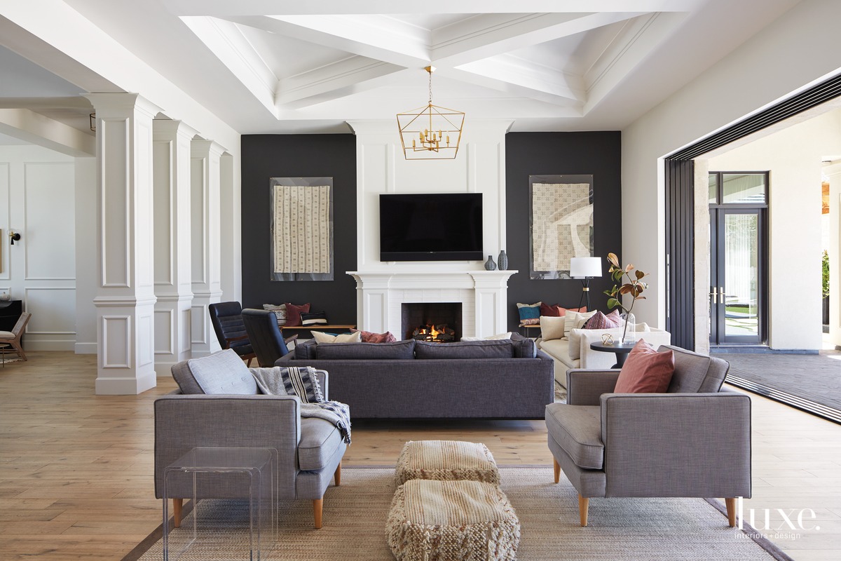 modern great room sitting area gray chairs and sofa firepace