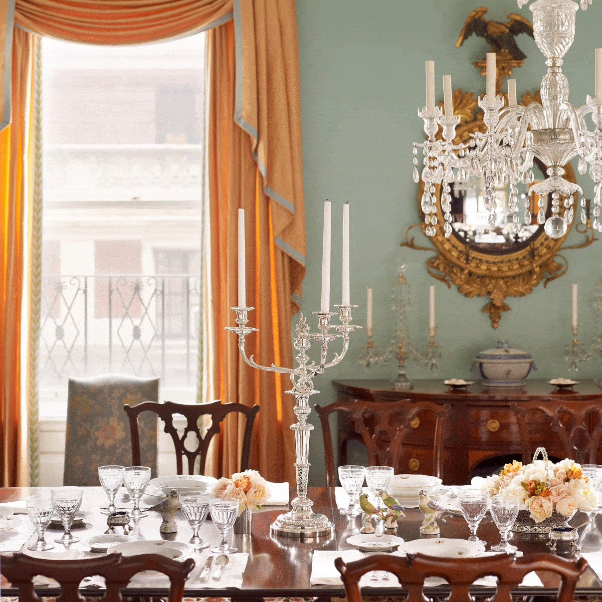 Classically designed curtains hang in the dining room of a New York apartment. Despite the beauty of curtains, Wharton and Codman preferred an enriched window casing or architrave.