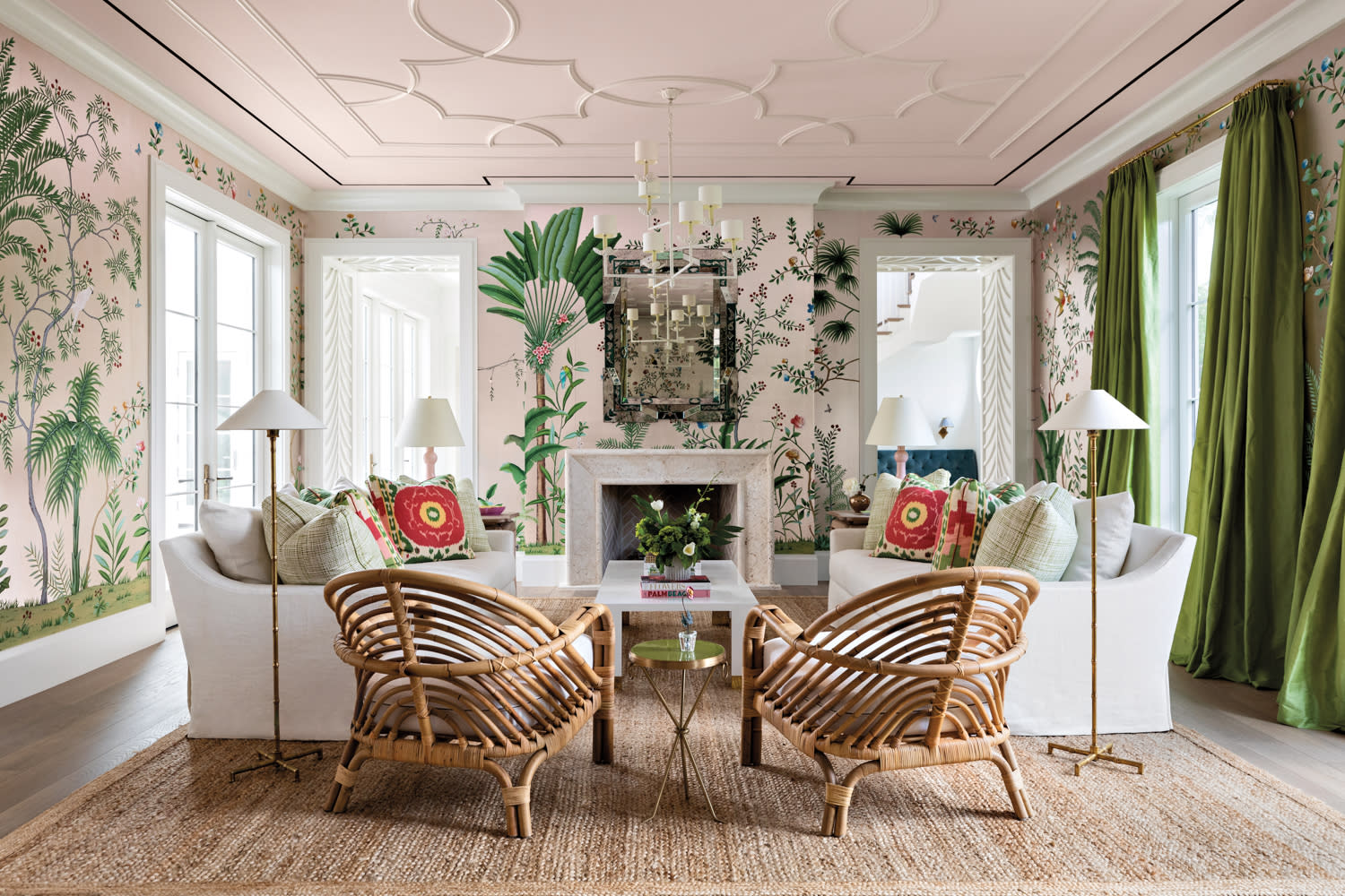 living area with tropical wallpaper, rattan chairs, sisal rug, floor lamps and white sofas