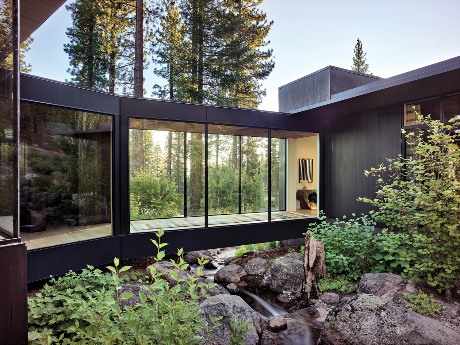 outdoor view of a mountain home's hall with large windows