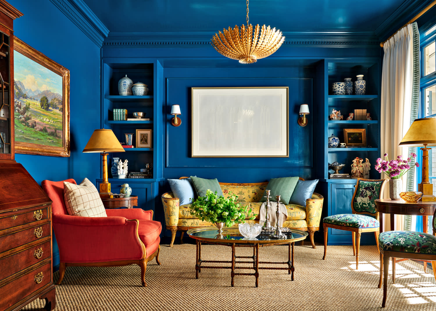 traditional living room with deep blue walls and built in shelving