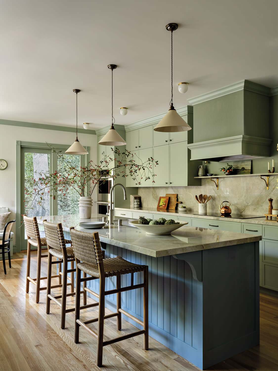 green and white kitchen with a blue island