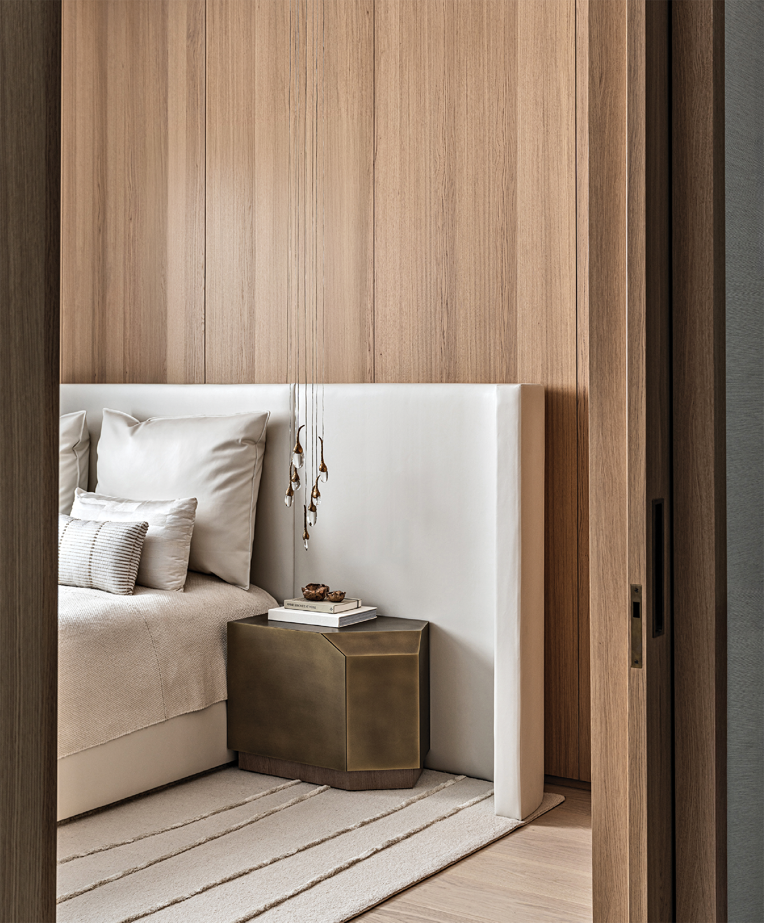 modern bedroom with a white bed and light oak walls