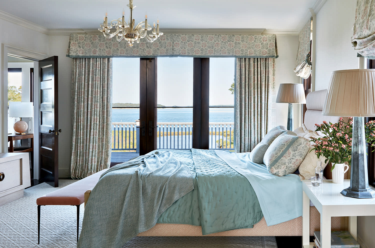 traditional bedroom with a seafoam green and blue palette and a vintage chandelier